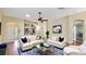 Staged living room with hardwood floors, bright light, bookshelves, and comfortable seating at 1156 Brandy Lake View Cir, Winter Garden, FL 34787