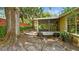 Cozy screened-in patio with brick and stone pavers surrounded by mature trees and greenery at 1156 Brandy Lake View Cir, Winter Garden, FL 34787