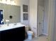 Modern bathroom features a double vanity with stylish fixtures and a framed art hanging on the wall at 11746 Water Run Aly, Windermere, FL 34786