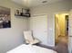 Cozy bedroom with a plush chair near the bed, built in closet, and doorway leading to another room at 11746 Water Run Aly, Windermere, FL 34786