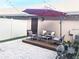 Charming patio with stylish seating, string lights, and a retractable umbrella at 11746 Water Run Aly, Windermere, FL 34786