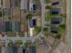 Aerial view features a modern home with solar panels, nestled in a residential neighborhood with well-kept yards at 119 Argyle Gate Loop Rd, Dundee, FL 33838
