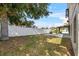 Spacious backyard with a patio, pergola, and a white privacy fence perfect for outdoor entertaining and relaxation at 119 Argyle Gate Loop Rd, Dundee, FL 33838