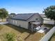 Aerial view of a backyard featuring solar panels, a covered patio, and a fire pit at 119 Argyle Gate Loop Rd, Dundee, FL 33838
