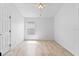Bright bedroom with wood-look tile flooring, a ceiling fan, and a window providing natural light at 119 Argyle Gate Loop Rd, Dundee, FL 33838