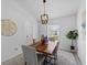 Dining room with wood table, decor, modern light fixture, rug, and plant at 119 Argyle Gate Loop Rd, Dundee, FL 33838