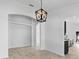 Dining area showcasing modern lighting and neutral walls, adjacent to the kitchen at 119 Argyle Gate Loop Rd, Dundee, FL 33838