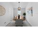 Formal dining room with wood table, decor, and a modern chandelier at 119 Argyle Gate Loop Rd, Dundee, FL 33838