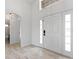 Bright foyer featuring wood-look flooring, white walls, and a clear view into the adjacent bathroom at 119 Argyle Gate Loop Rd, Dundee, FL 33838