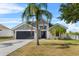 Charming single-story home with a well-maintained lawn, gray exterior, and a two-car garage at 119 Argyle Gate Loop Rd, Dundee, FL 33838