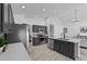 Modern kitchen featuring dark cabinets, island, stone countertops, and steel appliances at 119 Argyle Gate Loop Rd, Dundee, FL 33838