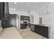 Well-appointed kitchen with dark cabinetry, stainless steel appliances, and an island overlooking living area at 119 Argyle Gate Loop Rd, Dundee, FL 33838