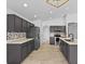 Contemporary kitchen with granite countertops, gray cabinets, tile backsplash, and stainless appliances at 119 Argyle Gate Loop Rd, Dundee, FL 33838