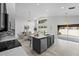 Open floor plan kitchen featuring dark cabinets, island, and a bright living room at 119 Argyle Gate Loop Rd, Dundee, FL 33838