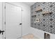 Laundry room featuring stylish wallpaper, open shelving, and connections for a washer and dryer at 119 Argyle Gate Loop Rd, Dundee, FL 33838