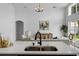 An open concept living space with views from the kitchen, featuring a large white couch and high ceilings at 119 Argyle Gate Loop Rd, Dundee, FL 33838