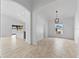Bright, open-concept living room featuring light-colored tile flooring and a view into the kitchen at 119 Argyle Gate Loop Rd, Dundee, FL 33838