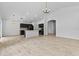 Spacious living area featuring wood-look floors, modern lighting, and a contemporary kitchen with dark wood cabinets at 119 Argyle Gate Loop Rd, Dundee, FL 33838