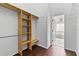 Walk-in closet with wood-look floor and built in wooden shelves at 119 Argyle Gate Loop Rd, Dundee, FL 33838