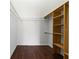 Walk-in closet features wooden shelving, wire shelving, and wood-look flooring at 119 Argyle Gate Loop Rd, Dundee, FL 33838