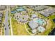 Aerial view of community amenities including a pool, splash pad, tennis courts, and community center at 13864 Destin Beach Ln, Orlando, FL 32827