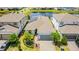 An aerial view of the house with solar panels, landscaping, and a nearby pond at 13864 Destin Beach Ln, Orlando, FL 32827
