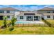 The backyard has a pool, patio with furniture, and is surrounded by a black metal fence at 13864 Destin Beach Ln, Orlando, FL 32827