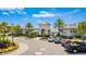 The clubhouse exterior is surrounded by landscaping, palm trees, and parking at 13864 Destin Beach Ln, Orlando, FL 32827