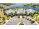 An aerial view of the clubhouse and community pool, landscaped with palm trees and parking spaces at 13864 Destin Beach Ln, Orlando, FL 32827