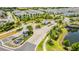 Aerial view of the community entrance with lush landscaping, pond and decorative fountains at 13864 Destin Beach Ln, Orlando, FL 32827
