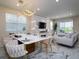 Open dining area with stylish lighting, a large table, and modern decor that connects to the living space at 13864 Destin Beach Ln, Orlando, FL 32827