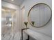 Bright hallway with marble floors, modern decor, and a decorative mirror at 13864 Destin Beach Ln, Orlando, FL 32827