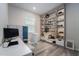Bright home office with a modern desk, ample shelving, and natural light, perfect for productivity at 13864 Destin Beach Ln, Orlando, FL 32827