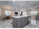 Spacious open-concept kitchen with a large island, modern lighting, and marble flooring at 13864 Destin Beach Ln, Orlando, FL 32827