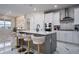 Modern kitchen featuring a large island with seating, stainless steel appliances, and stylish pendant lighting at 13864 Destin Beach Ln, Orlando, FL 32827