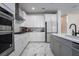Open concept kitchen with white cabinets, marble floors, and stainless steel appliances at 13864 Destin Beach Ln, Orlando, FL 32827