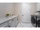 The laundry room is furnished with a washer, dryer, sink, and counter at 13864 Destin Beach Ln, Orlando, FL 32827