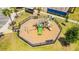 Aerial view of a modern playground with slides and climbing equipment in a fenced area at 13864 Destin Beach Ln, Orlando, FL 32827