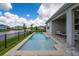 Backyard pool view showcasing a peaceful waterfront view surrounded by beautiful blue skies at 13864 Destin Beach Ln, Orlando, FL 32827