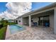 A refreshing pool with a serene waterfront view creates a perfect outdoor oasis at 13864 Destin Beach Ln, Orlando, FL 32827