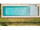 Aerial view of a backyard pool with a tanning ledge and well-maintained landscaping at 13864 Destin Beach Ln, Orlando, FL 32827