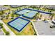 Aerial view of well-maintained tennis courts and a basketball court in a community at 13864 Destin Beach Ln, Orlando, FL 32827