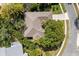 Aerial view of a well-maintained home with mature trees and a neat roof at 14841 Faversham Cir, Orlando, FL 32826