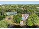 Stunning aerial view showcasing a tennis court, pool, and gazebo overlooking the lake at 14841 Faversham Cir, Orlando, FL 32826