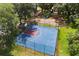 Community basketball court with a fenced perimeter and playground in the background at 14841 Faversham Cir, Orlando, FL 32826