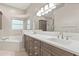 Elegant bathroom with double vanity, soaking tub, and neutral color palette at 14841 Faversham Cir, Orlando, FL 32826