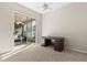 Bright bedroom featuring neutral carpeting, ceiling fan, and sliding glass doors leading to a screened lanai at 14841 Faversham Cir, Orlando, FL 32826