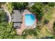 Aerial view of the community swimming pool featuring ample seating and mature landscaping at 14841 Faversham Cir, Orlando, FL 32826