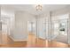 Inviting entryway with hardwood floors, natural light, and views into other rooms at 14841 Faversham Cir, Orlando, FL 32826