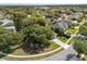 Aerial view of a home nestled among lush trees in a well-developed neighborhood at 14841 Faversham Cir, Orlando, FL 32826